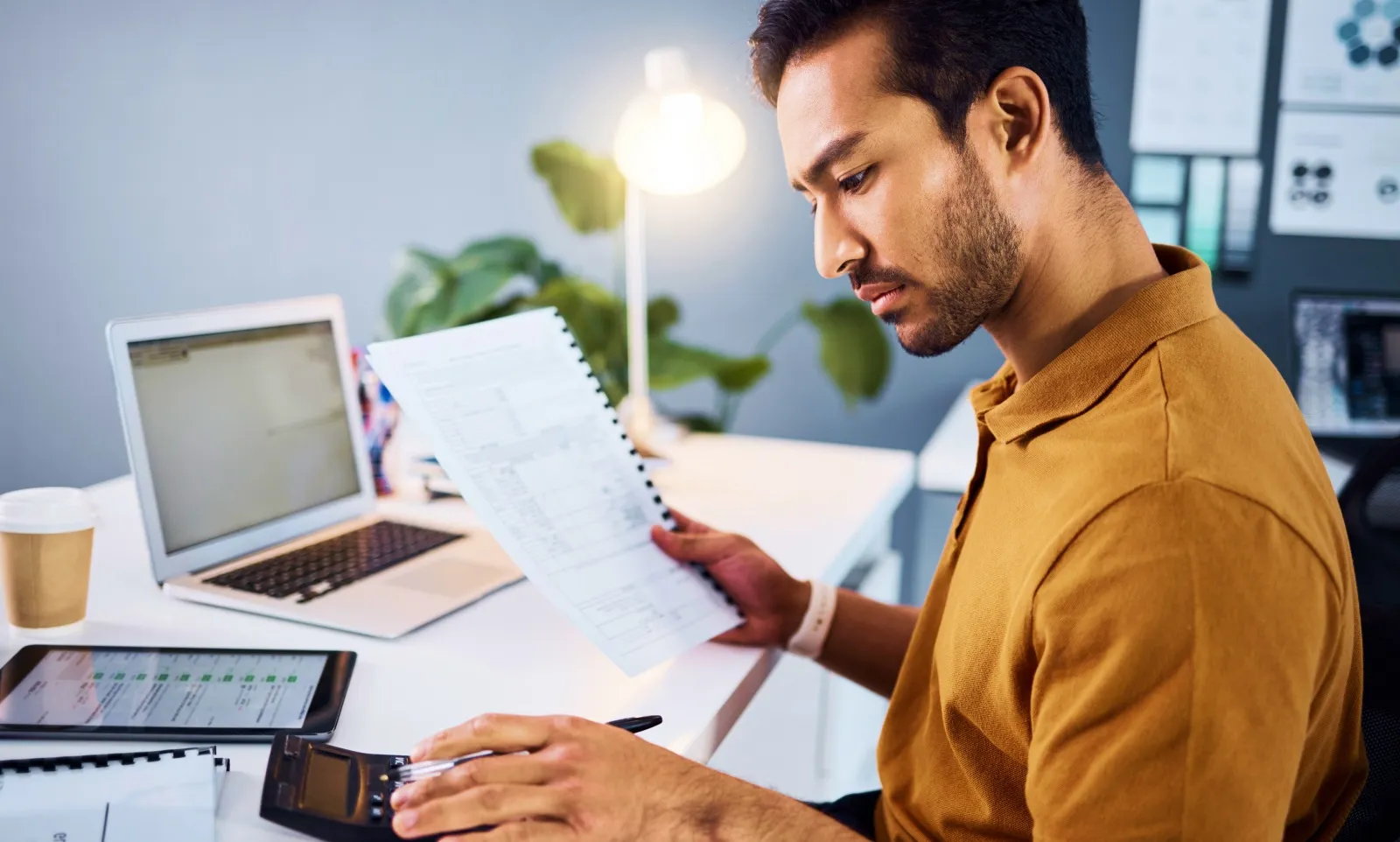 Professional working on a laptop at an office desk
